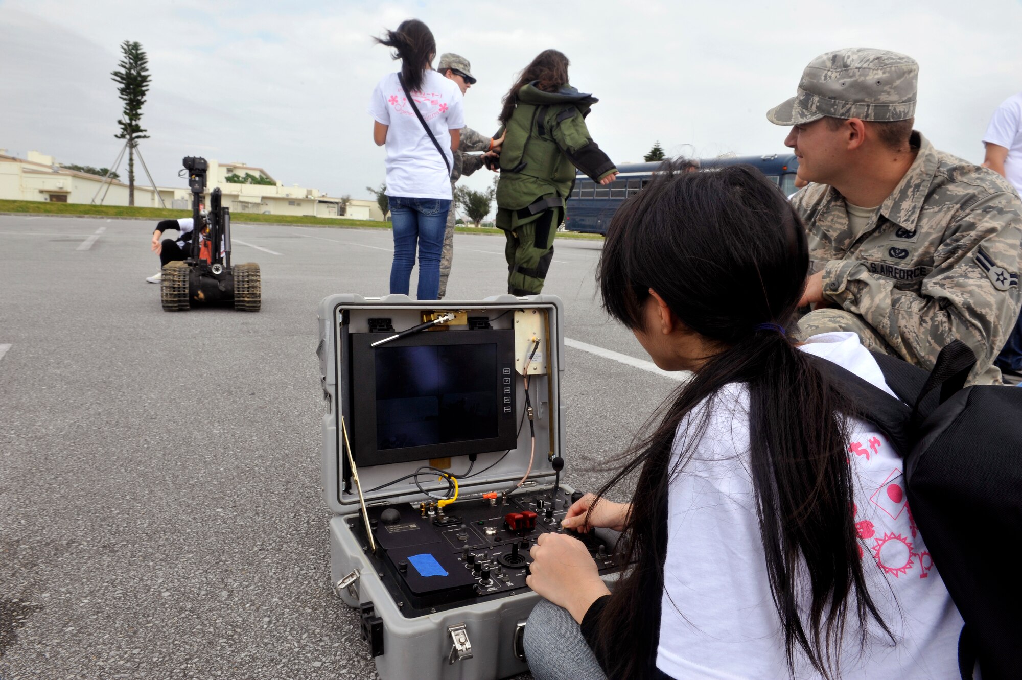Children from Okinawan foster homes try to operate an explosive ordinance disposal robot during Operation Sakura on Kadena Air Base, Japan, March 28, 2014. Throughout the day, the children were given demonstrations by HH-60 Pave Hawk pararescueman, military working dog handlers, and explosive ordinance disposal Airmen, and were participants during field events. (U.S. Air Force photo by Naoto Anazawa)