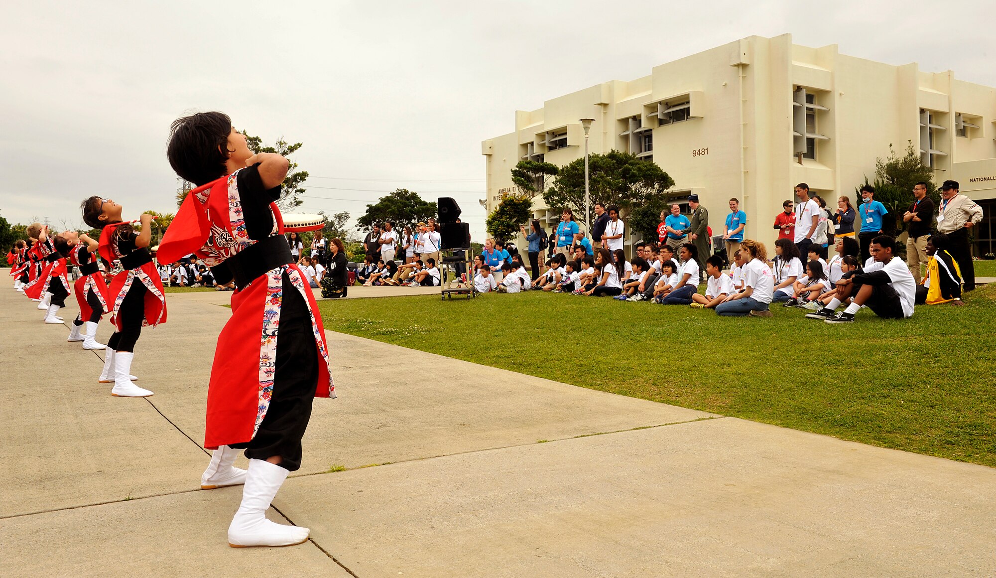 Members of Fire Bird Taiko Club from Amelia Earhart Intermediate School perform for children from Okinawan foster homes during Operation Sakura on Kadena Air Base, Japan, March 28, 2014. Okinawan children interacted with American children of their own ages in an effort to learn more about the base and mission of the 18th Wing. (U.S. Air Force photo by Naoto Anazawa)
