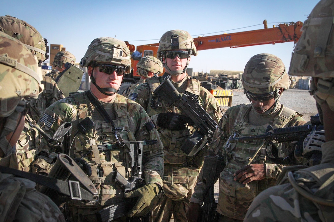 U.S. soldiers receive a post-patrol mission brief on Forward Operating ...