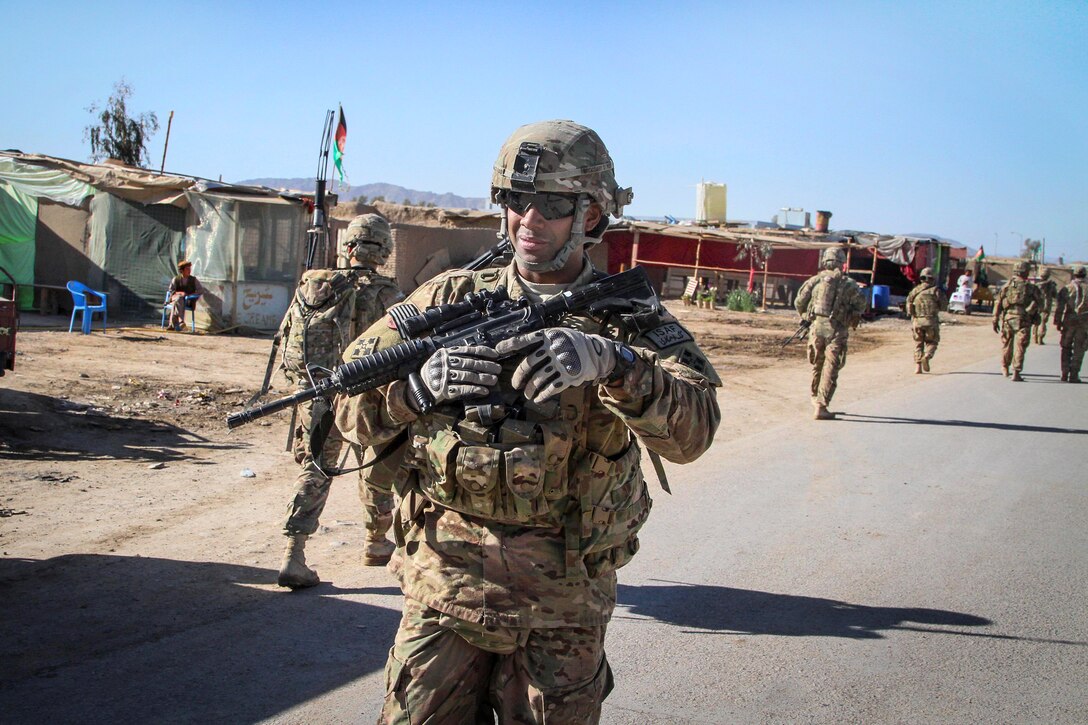 U.S. Army Sgt. Gilberto Garcia-Acevedo directs a presence patrol in ...