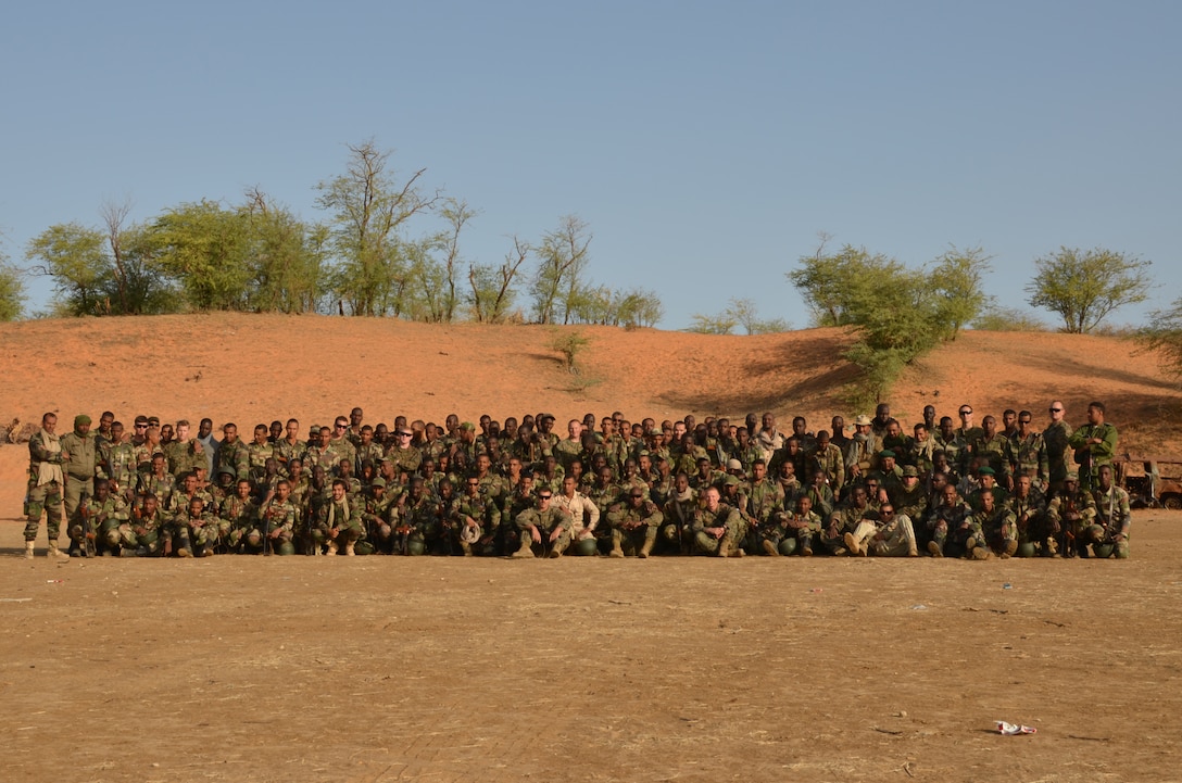 Marines with Special-Purpose Marine Air-Ground Task Force Africa 14.1 pose for a photo with the Mauritanian Fusiliers Marins and Gendarmarie, March 12, 2014, after completing a live-fire range in Rosso, Mauritania. The theater security cooperation team was in Mauritania to train and advise their counterparts, on infantry skills, marksmanship, patrolling skills, first aid and combat lifesaving skills, small boat operations and mission planning for leadership.
