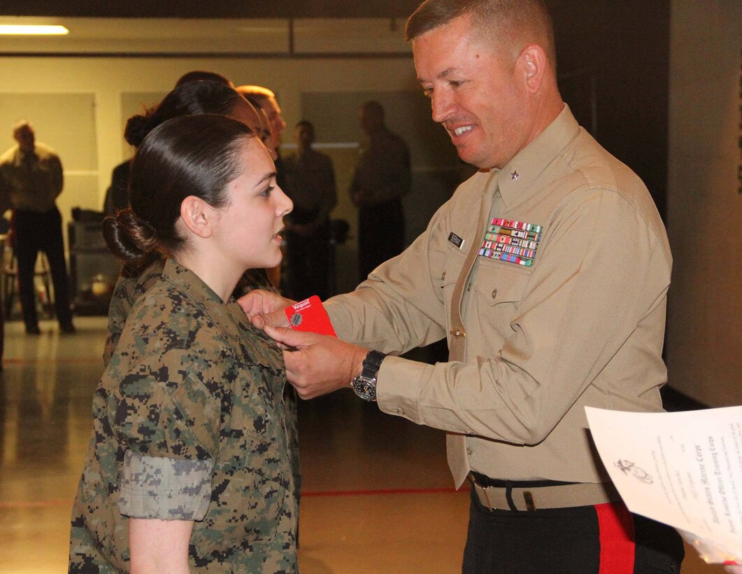 Brig. Gen. James Bierman, Commanding General, Marine Corps Recruit Depot, San Diego and Western Recruiting Region, pins a Ben Davis High School JROTC student with her next rank, April, 1. 
(courtesy photo)