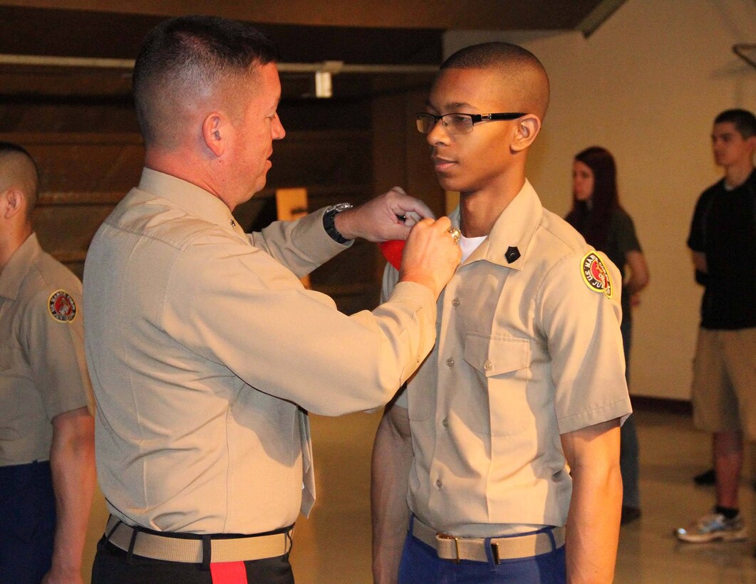 Brig. Gen. James Bierman, Commanding General, Marine Corps Recruit Depot, San Diego and Western Recruiting Region, pins a Ben Davis High School JROTC student with his next rank, April, 1. 
(courtesy photo)