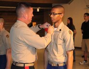 Brig. Gen. James Bierman, Commanding General, Marine Corps Recruit Depot, San Diego and Western Recruiting Region, pins a Ben Davis High School JROTC student with his next rank, April, 1. 
(courtesy photo)