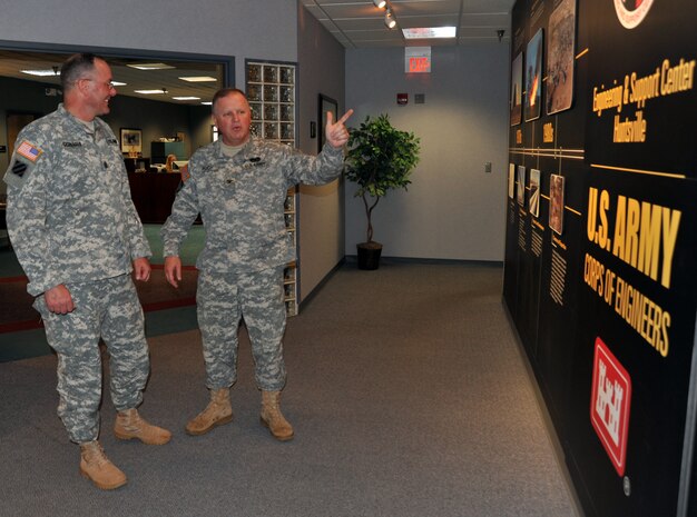 Huntsville Center commander Col. Robert Ruch explains the Center's history to USACE Command Sgt. Maj. Karl  Groninger in front of the Center's timeline wall. The timeline wall displays points in the Center's history and spotlights past and present mission functions. Groninger was at the Center for a site visit and to learn more about the Huntsville Center mission and capabilities.