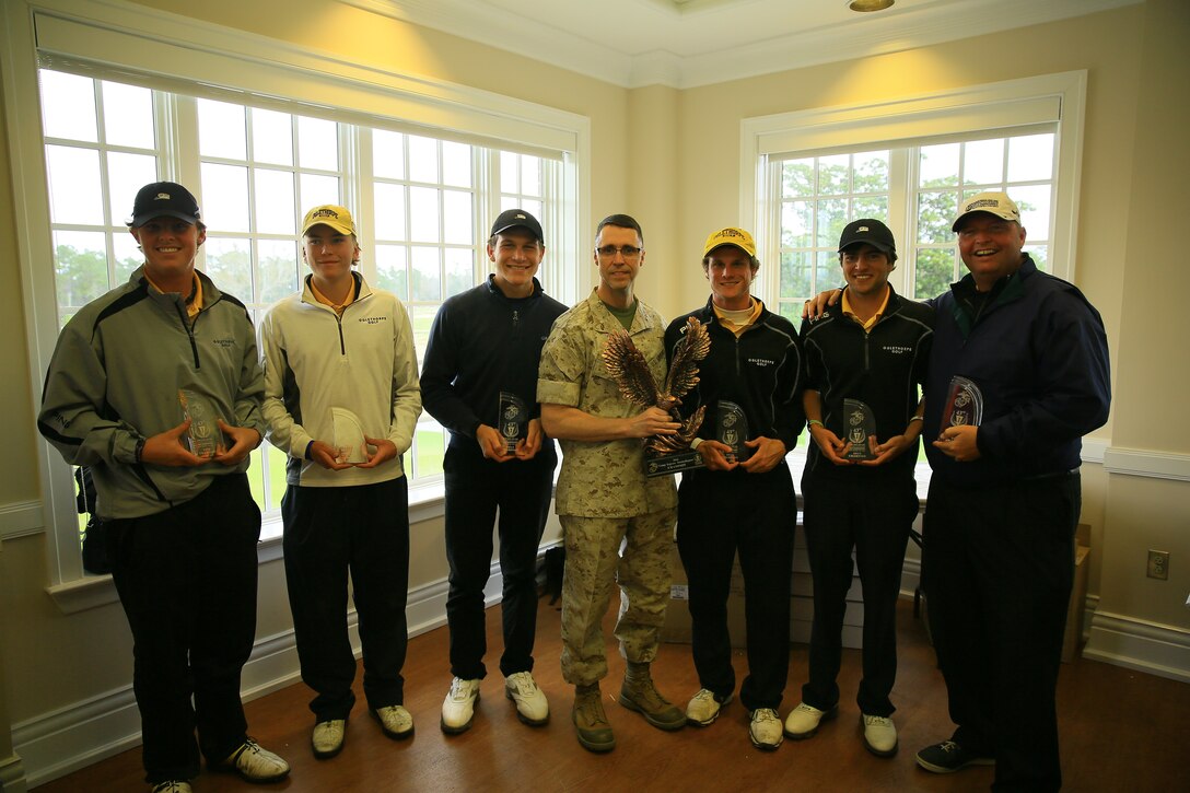 Brig. Gen. Robert Castellvi (center), commanding general of Marine Corps Base Camp Lejeune, presents Oglethorpe University with the coveted team trophy for winning the 43rd annual Marine Federal Credit Union Intercollegiate Golf Championship at the Paradise Point Golf Course aboard Marine Corps Base Camp Lejeune, March 30. Oglethorpe’s team scored a combined low of 575 to beat 31 other teams for the trophy.