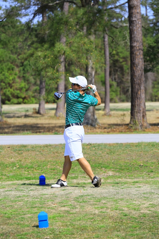 Greg Gentry, a golfer from Webber International University, drives his ball down the fairway at the 43rd annual Marine Federal Credit Union Intercollegiate Golf Championship at the Paradise Point Golf Course aboard Marine Corps Base Camp Lejeune, March 28. Thirty-two teams from across the country compete to win the trophy each year and Oglethorpe University was crowned the winner for 2014.