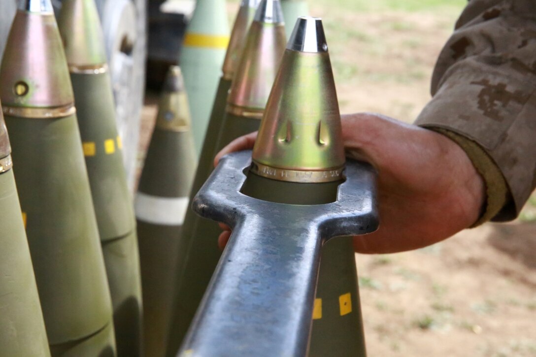 A Marine with India Battery, 1st Battalion, 11th Marine Regiment, prepares to load a high explosive round into a M777A2 Howitzer during a week-long battalion fire exercise held aboard Marine Corps Base Camp Pendleton, Calif., March 27, 2014. There's a variety of rounds including white phosphorous, illumination and smoke rounds that can exceed 100lbs. (U.S. Marine Corps photo by Lance Cpl. Jonathan Boynes/released)