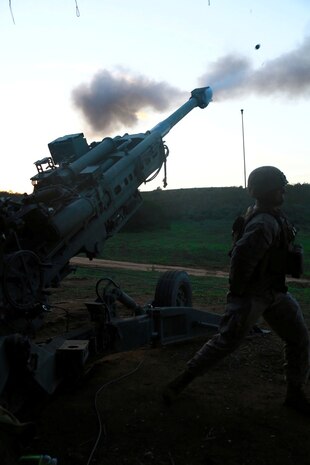 Corporal Thomas Way a cannoneer with India Battery, 1st Battalion, 11th Marine Regiment, and a native of  Conifer, Colo., fires a M777A2 Howitzer during a battalion fire exercise aboard Marine Corps Base Camp Pendleton, Calif., March 27, 2014. The week-long exercise tested the battalion's ability to effectively operate their weapon systems during the large-scale exercise. India Battery's skills were on display as they fired round after round accurately engaging their targets. (U.S. Marine Corps photo by Lance Cpl. Jonathan Boynes/released)
