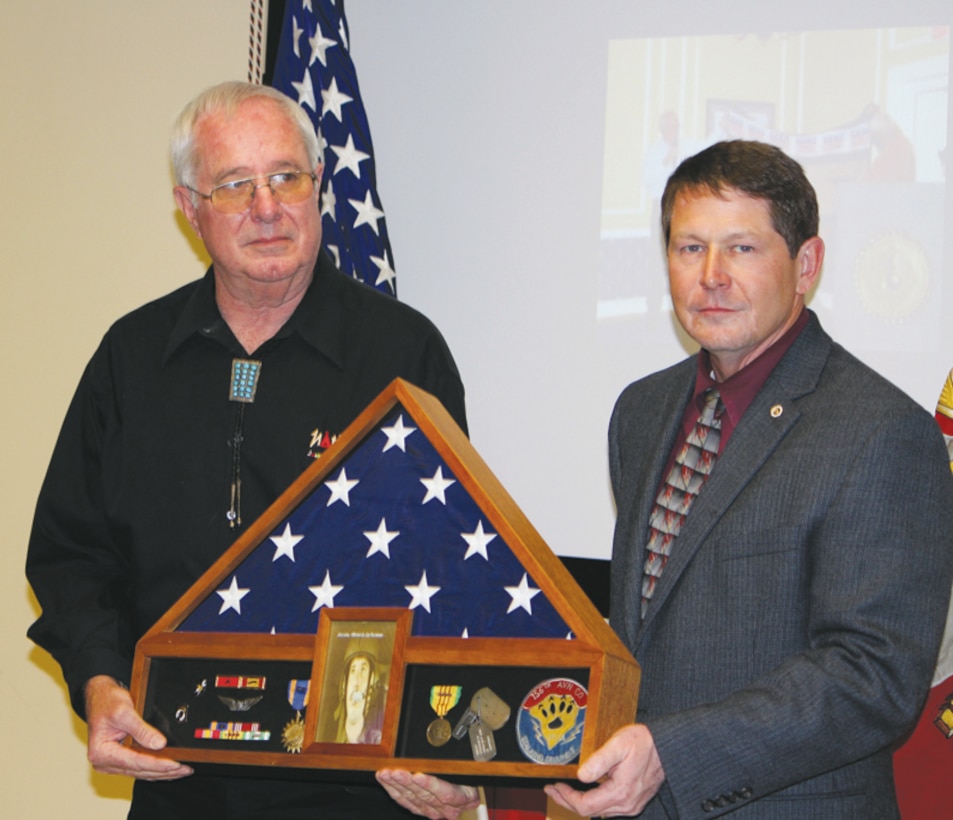 Jerry Laney (left) safety coordinator, C4, Marine Corps Logistics Command, receives a shadow box from Hal Gobin, director, C4, LOGCOM, at his retirement March 27 in LOGCOM's Multipurpose Room, Building 3700.
