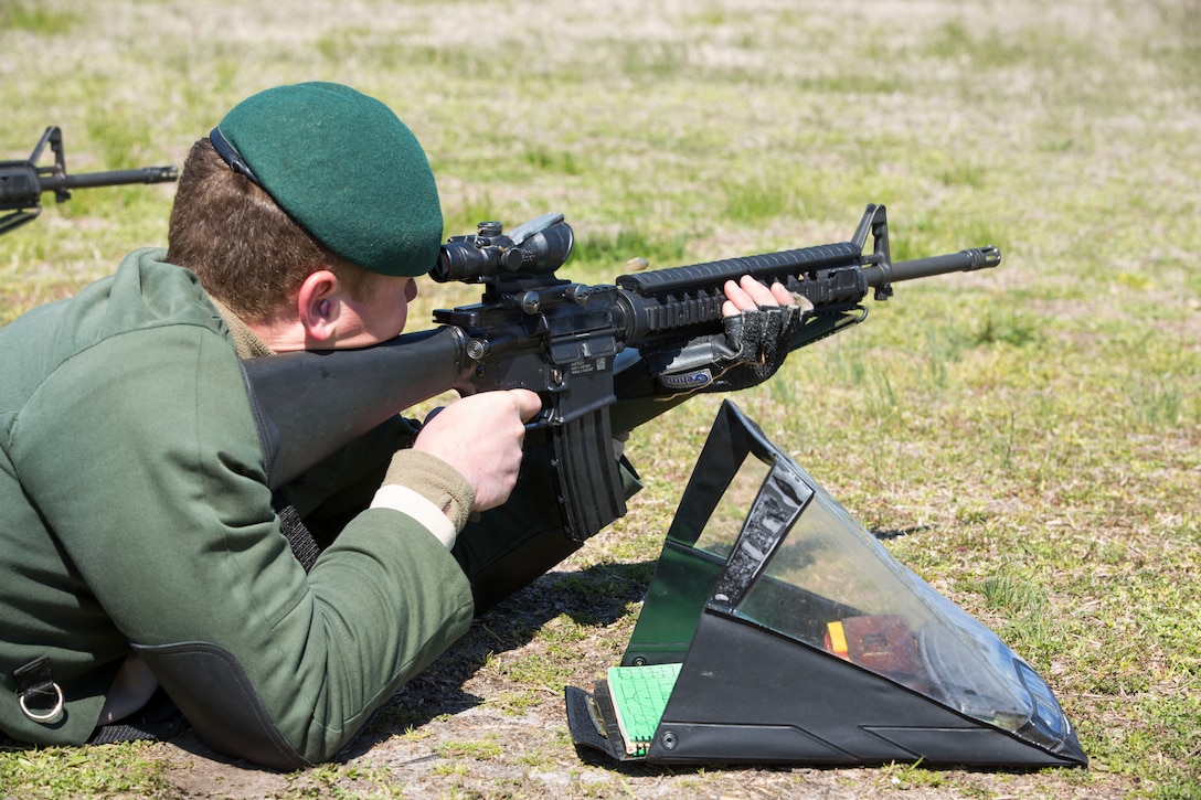A British Royal Marine shoots the M16-A4 Service Rifle during the 2014 Eastern Division Rifle and Pistol Competition aboard Stone Bay Rifle Range, March 21. The event serves as a venue for participants to showcase their skill and compete against each other. (Photo by Lance Cpl. Justin A. Rodriguez/released)