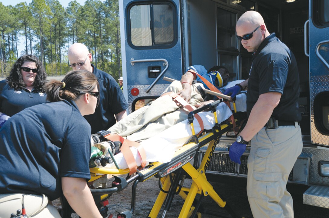First responders prepare to transport a simulated victim for treatment during the Twisting Thunder 2014 exercise, Tuesday. The two-day destructive-weather exercise was held at Marine Corps Logistics Base Albany.