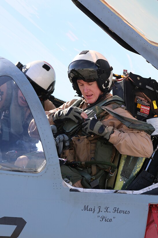 Captain Andrew Cody straps into an EA-6B Prowler on the Marine Corps Air Station flight line March 27, 2014. Cody is a part of the first class of pilots training at Marine Tactical Electronic Warfare Training Squadron 1 since it transitioned to a training squadron in June 2013.  