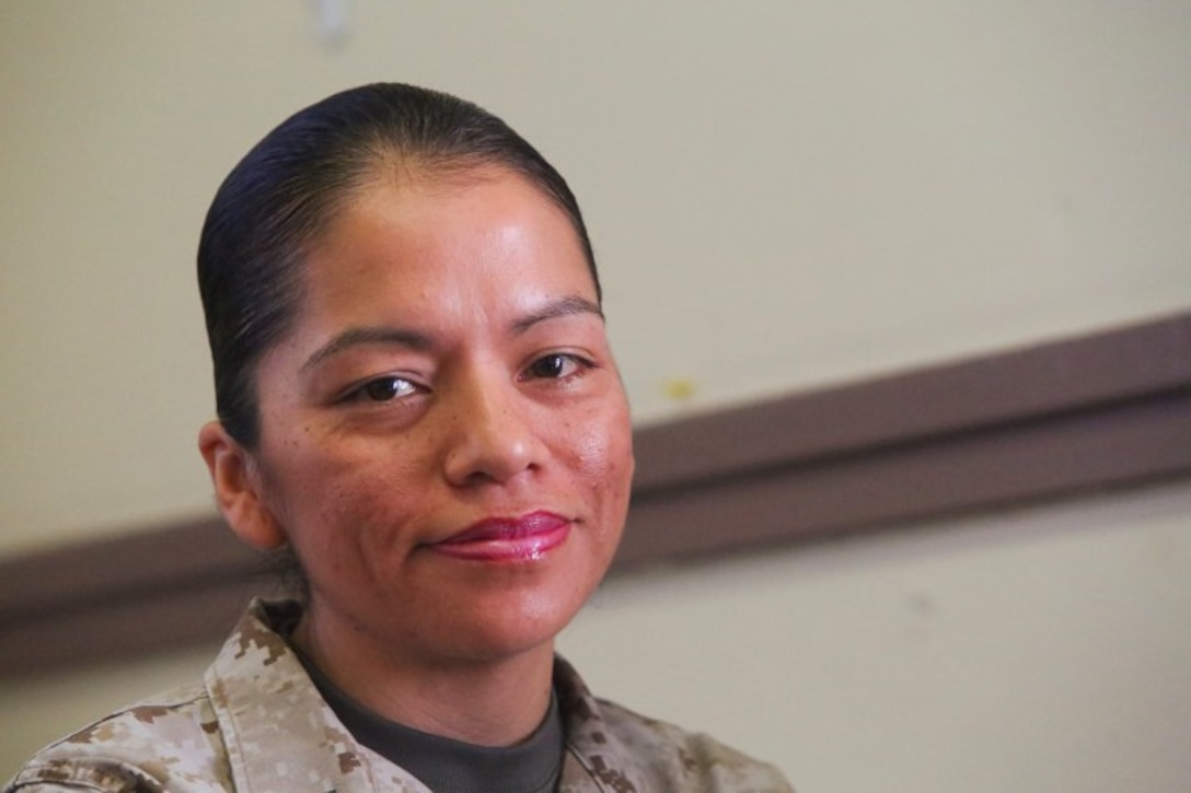 Gunnery Sgt. Yolanda E. Ayala, an intelligence chief with 1st Law Enforcement Battalion, works at her desk aboard Camp Pendleton, Calif., April 2. Ayala was selected as the Navy League 2014 Senior Enlisted Woman of the Year.