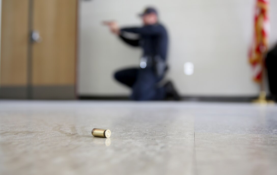 Officer Jason Frederickson, a civilian police officer with the Marine Corps Air Station Miramar Provost Marshal’s Office, provides rear security while a fellow officer clears a room at Navy Marine Reserve Center aboard MCAS Miramar, Calif., April 2. The scenarios conducted attempt to be as authentic as possible to aid readiness in the event of an active shooter.