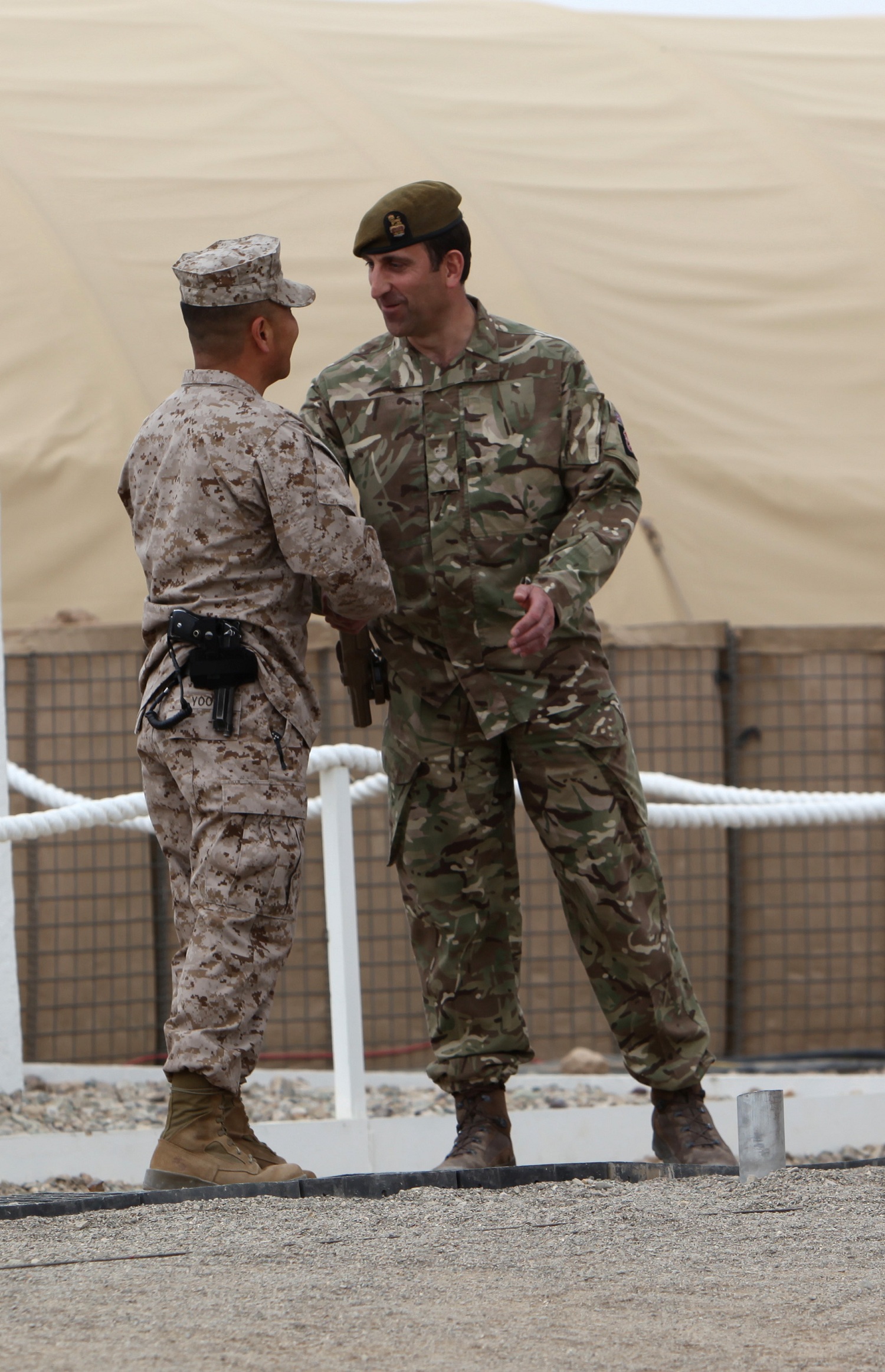 Brigadier Gen. Daniel Yoo, left, commander of Regional Command (Southwest), shakes hands with Brigadier James Woodham, commander of Task Force Helmand, as a symbol of Task Force Helmand’s merge with Regional Command (Southwest) during a ceremony aboard Camp Bastion, Afghanistan, April 1, 2014. Following eight years of combat operations in Helmand province, the ceremony marked the end of the United Kingdom’s military headquarters in southwestern Afghanistan. The functions of the British headquarters element now reside with RC(SW). The task force was established in April 2006 and has conducted 16 rotations since its beginning.



