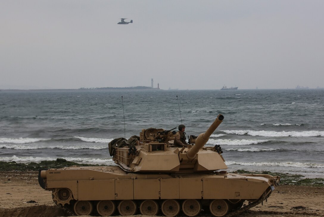 Marines with Charlie Company, 4th Tanks Battalion, drive a M1A1 Tank onto Dogue Beach during exercise Ssang Yong, Pohang, South Korea,  April 3, 2014. Exercise Ssang Yong is conducted annually in the ROK to enhance interoperability between U.S. and ROK forces by performing a full spectrum of amphibious operations while showcasing sea-based power projection in the Pacific. (U.S. Marine Corps photo by Cpl. Lauren Whitney/Released)