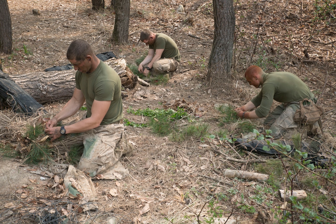 U.S. Marines prepare their ghillie suits to make it as stealthy as possible for a sniper stalking course April 3 during Ssang Yong 2014 at an urban combat training site in Pohang, Republic of Korea. A ghillie suit, also known as a yowie suit, or camo tent, is a type of camouflage clothing designed to resemble heavy foliage. The U.S. Marine Corps possesses a unique ability to come together with partner nations, conduct expeditionary planning, and execute a large-scale amphibious operation. The U.S. Marines pictured are with Scout Sniper Platoon, Weapons Company, 2nd Battalion, 3rd Marine Regiment, 3rd Marine Division. (U.S. Marine Corps photo by Lance Cpl. Cedric R. Haller II/RELEASED)