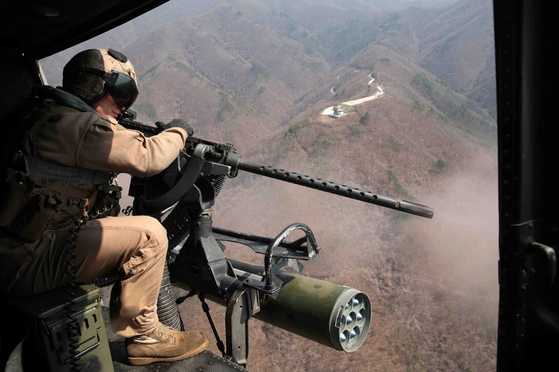 A U.S. Marine assigned to 13th Marine Expeditionary Unit controls the door gun on a UH-1Y Huey while conducting flight operations during Ssang Yong 14 in Pohang, South Korea, April 1, 2014.  Exercise Ssang Yong is conducted annually in the Republic of Korea to enhance the interoperability of U.S. and ROK forces by performing a full spectrum of amphibious operations while showcasing sea-based power projection in the Pacific. (Official U.S. Marine Corps photo by Cpl. David Gonzalez/Released)