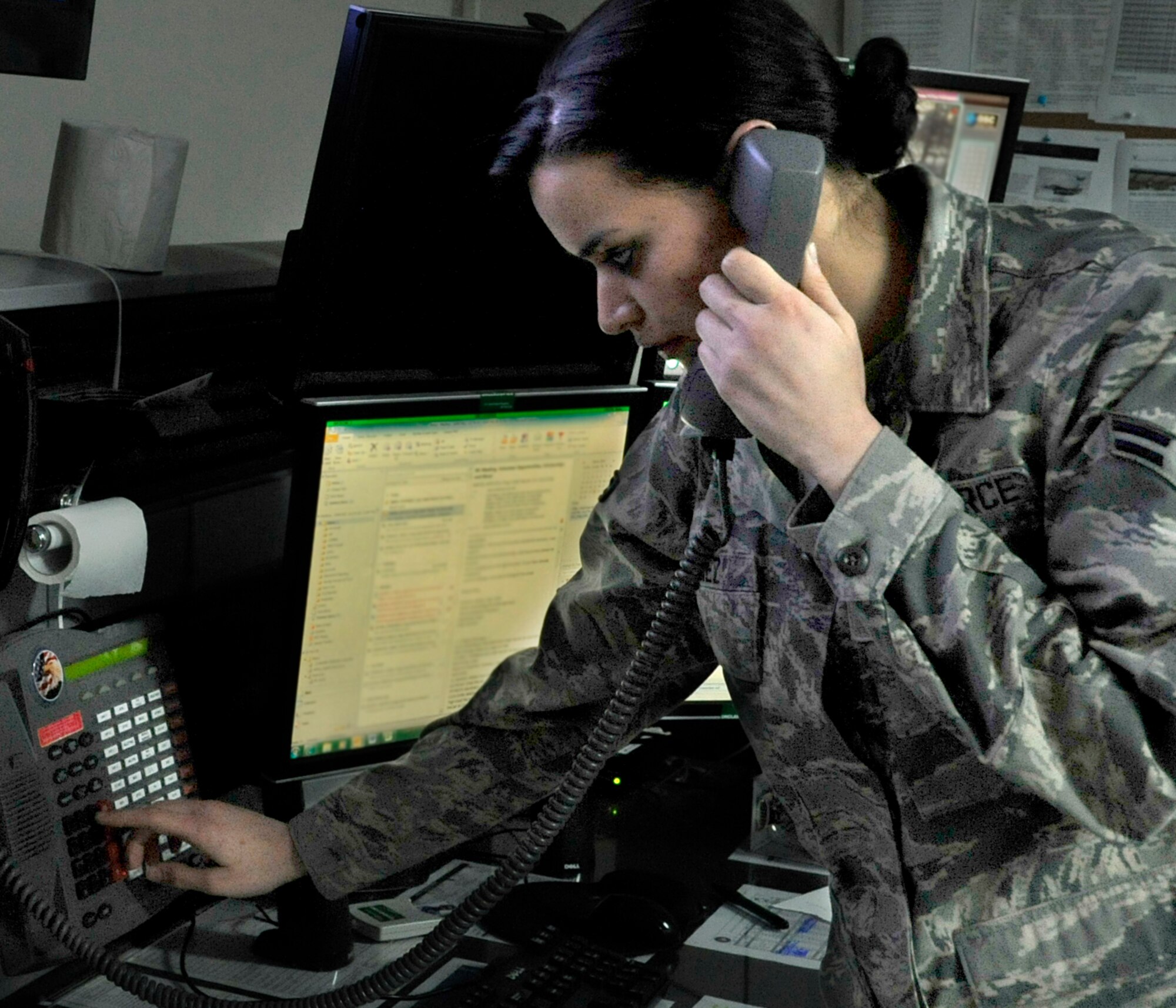 U.S. Air Force Airman 1st Class Luz Sanchez, Command Post emergency actions controller, responds to a call at Misawa Air Base, Japan, March 26, 2014. Sanchez is responsible for coordinating with various squadrons for emergencies, updating weather and tracking the status of aircraft. (U.S. Air Force photo/Airman 1st Class Patrick S. Ciccarone)