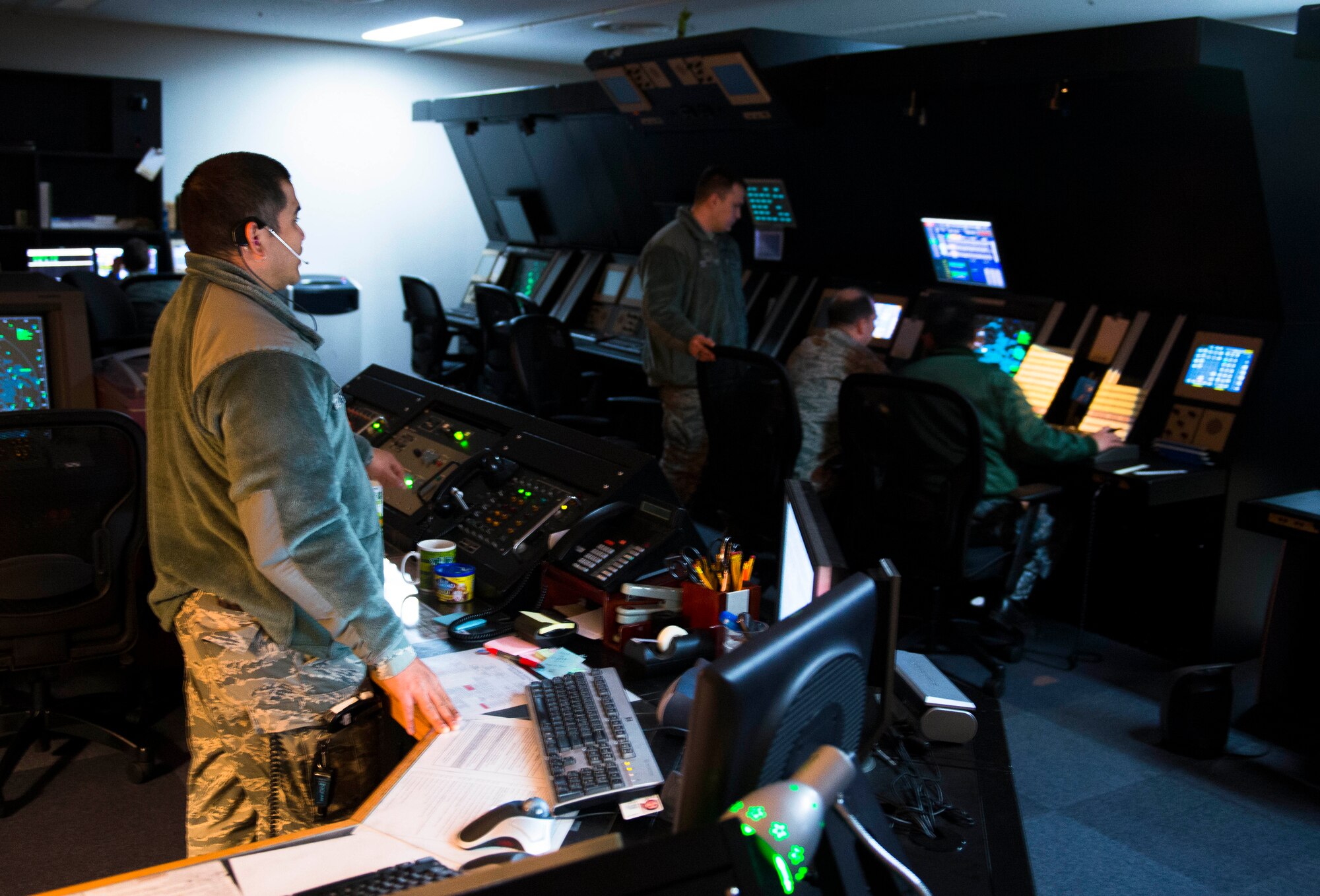 374th Operations Support Squadron radar approach controllers assist a C-130 Hercules during an in-flight emergency April 3, 2014, Yokota Air Base, Japan. RAPCON handles all aircraft within 60 nautical miles compared to five nautical miles the tower controls. (U.S. Air Force photo by Staff Sgt. Chad C. Strohmeyer/Released)