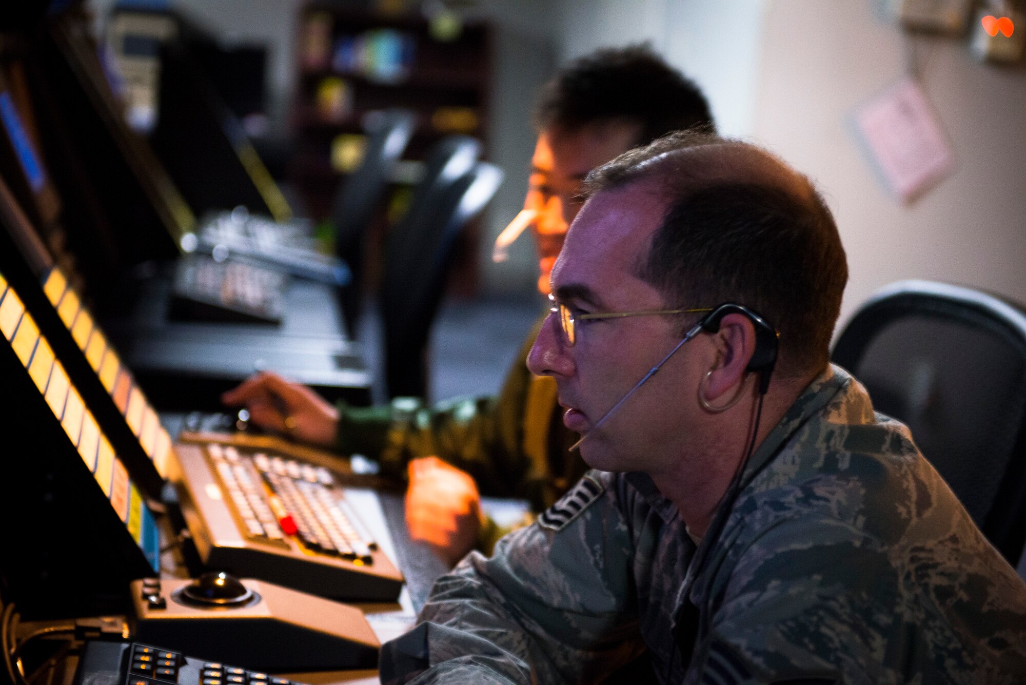 Tech. Sgt. Scott Fourre, 374th Operations Support Squadron radar approach controller, communicates with a C-130 Hercules during an in-flight emergency April 3, 2014, Yokota Air Base, Japan. Fourre communicated with the pilot, who landed safely, until communications were transferred to the tower. (U.S. Air Force photo by Staff Sgt. Chad C. Strohmeyer/Released)