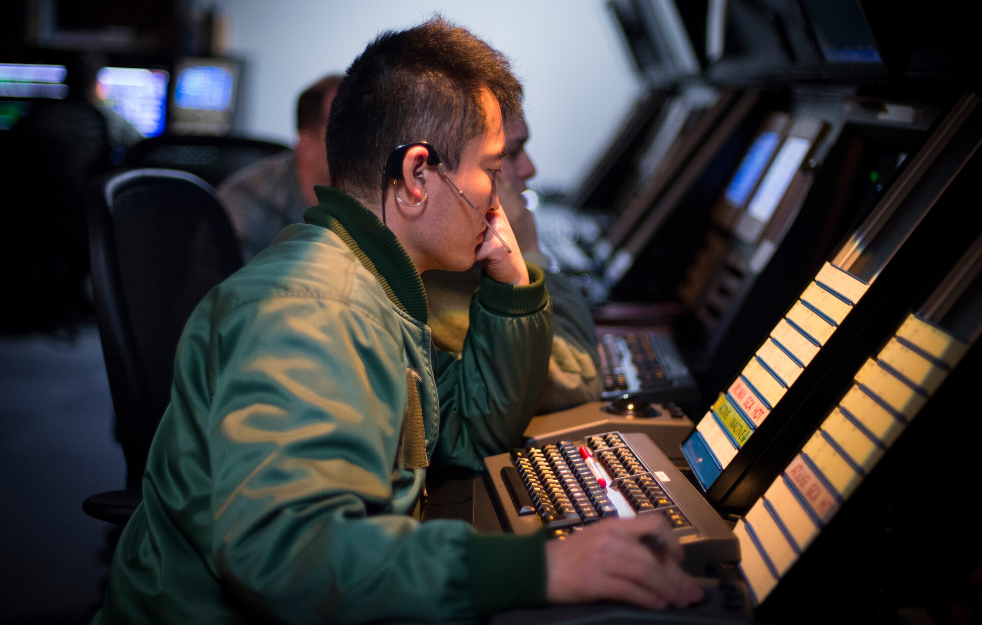 Capt. Yasuyuki Sakamoto, Japan Air Self-Defense Force radar approach controller, transfers incoming aircraft to the air traffic control tower April 3, 2014, Yokota Air Base, Japan. RAPCON handles all aircraft within 60 nautical miles compared to five nautical miles the tower controls. (U.S. Air Force photo by Staff Sgt. Chad C. Strohmeyer/Released)