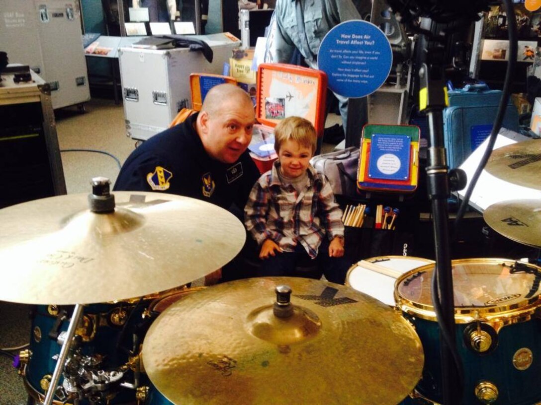 Max Impact performed live at the Smithsonian Air and Space Museum on March 28 at 11, 12, 1 and 2 pm.  Pictured here, TSgt Robert Smith had a teachable moment with a young fan and drummer. (US Air Force Photo/released)
