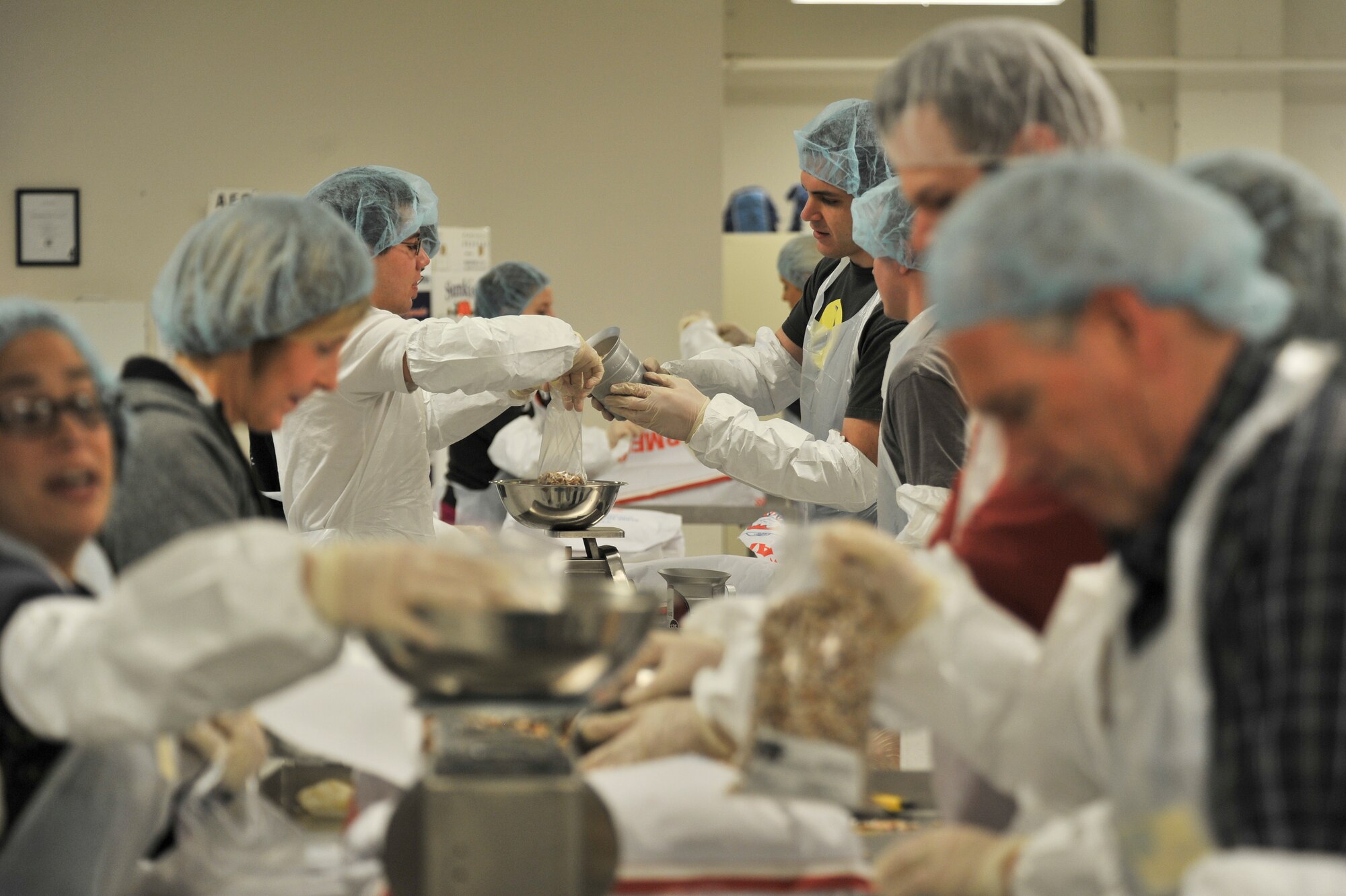 Students from the 66th Training Squadron and local community members work together to fill bags with beans for packaging at Second Harvest Relief Network Spokane, Wash. March 31, 2014. Second Harvest has been serving the local community since 1971. Airmen from Fairchild have helped throughout the years to provide more than 2 Million pounds of food for families in 250 neighborhoods each year. (U.S. Air Force photo by Staff Sgt. Alexandre Montes /Released)