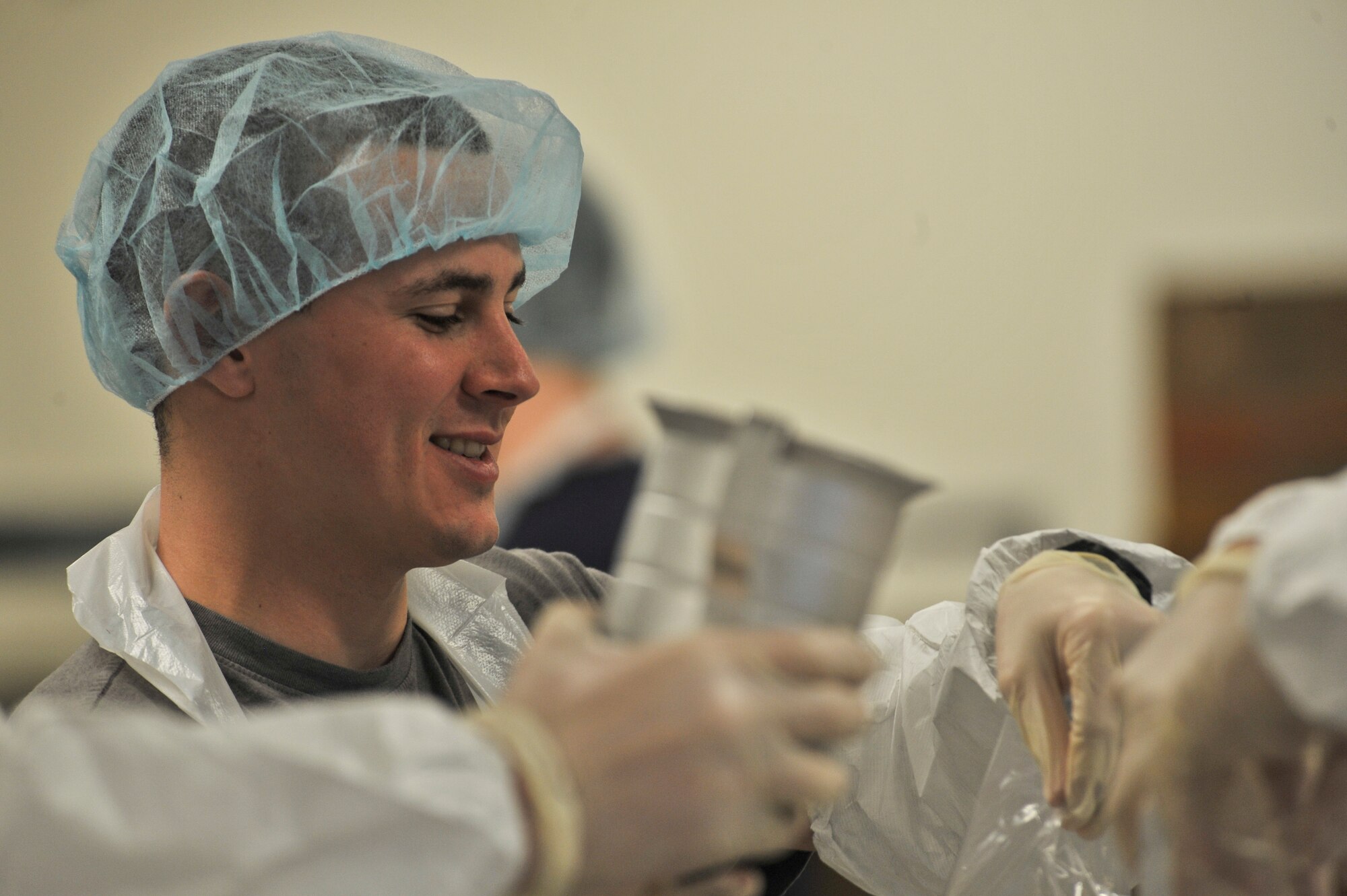 A student from the 66th Training Squadron fill bags with beans for packaging at Second Harvest Relief Network Spokane, Wash. March 31, 2014. Second Harvest has been serving the local community since 1971. Airmen from Fairchild have helped throughout the years to provide more than 2 Million pounds of food for families in 250 neighborhoods each year.  (U.S. Air Force photo by Staff Sgt. Alexandre Montes/Released)
