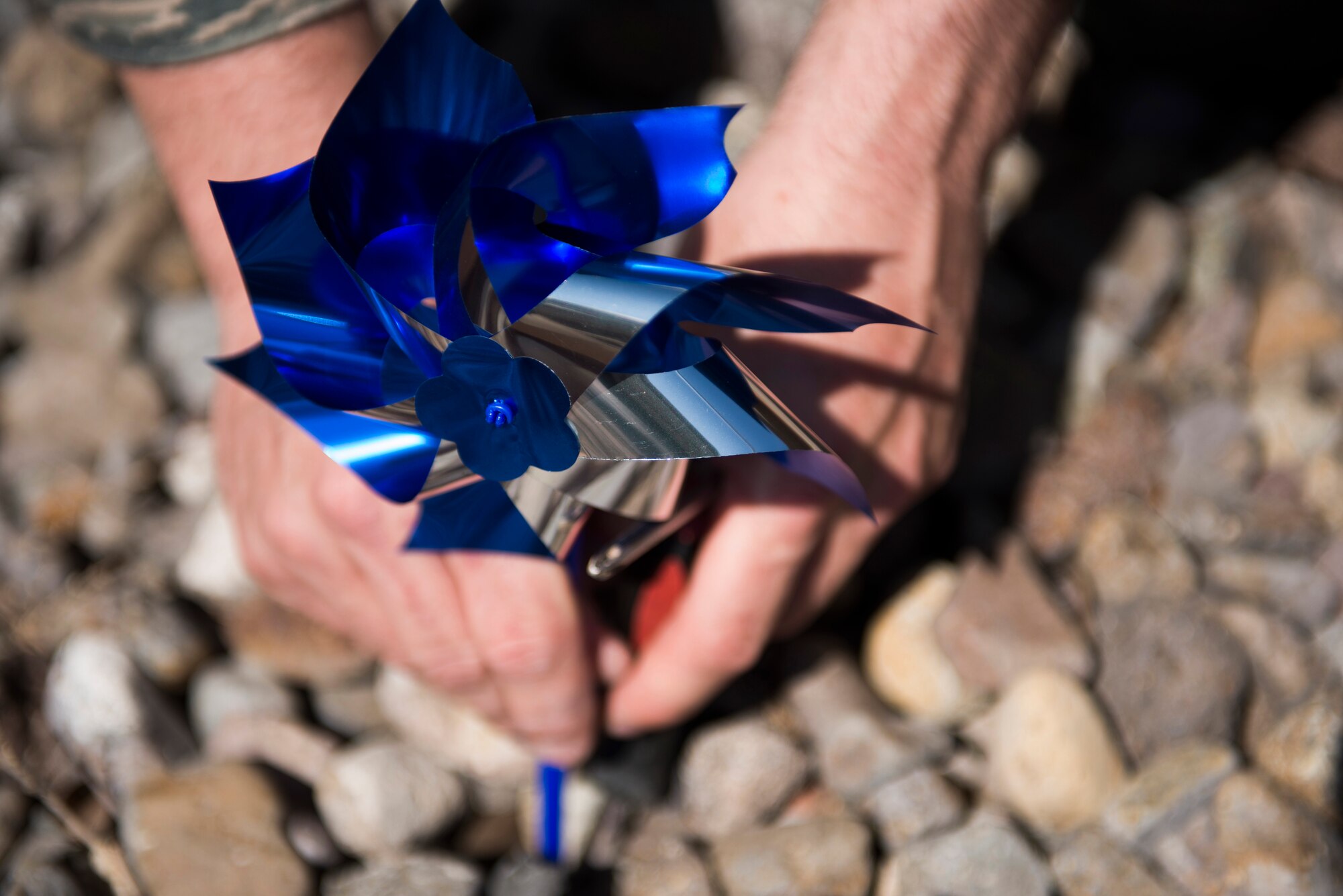 First Sergeants and volunteers plant pinwheels for child abuse awareness at Mountain Home Air Force Base, Idaho, April 3, 2014. Blue pinwheels are planted to recognize National Child Abuse Prevention Month, which aims to bring attention to child abuse. (U.S. photo by Airman 1st Class Malissa Lott/RELEASED)
