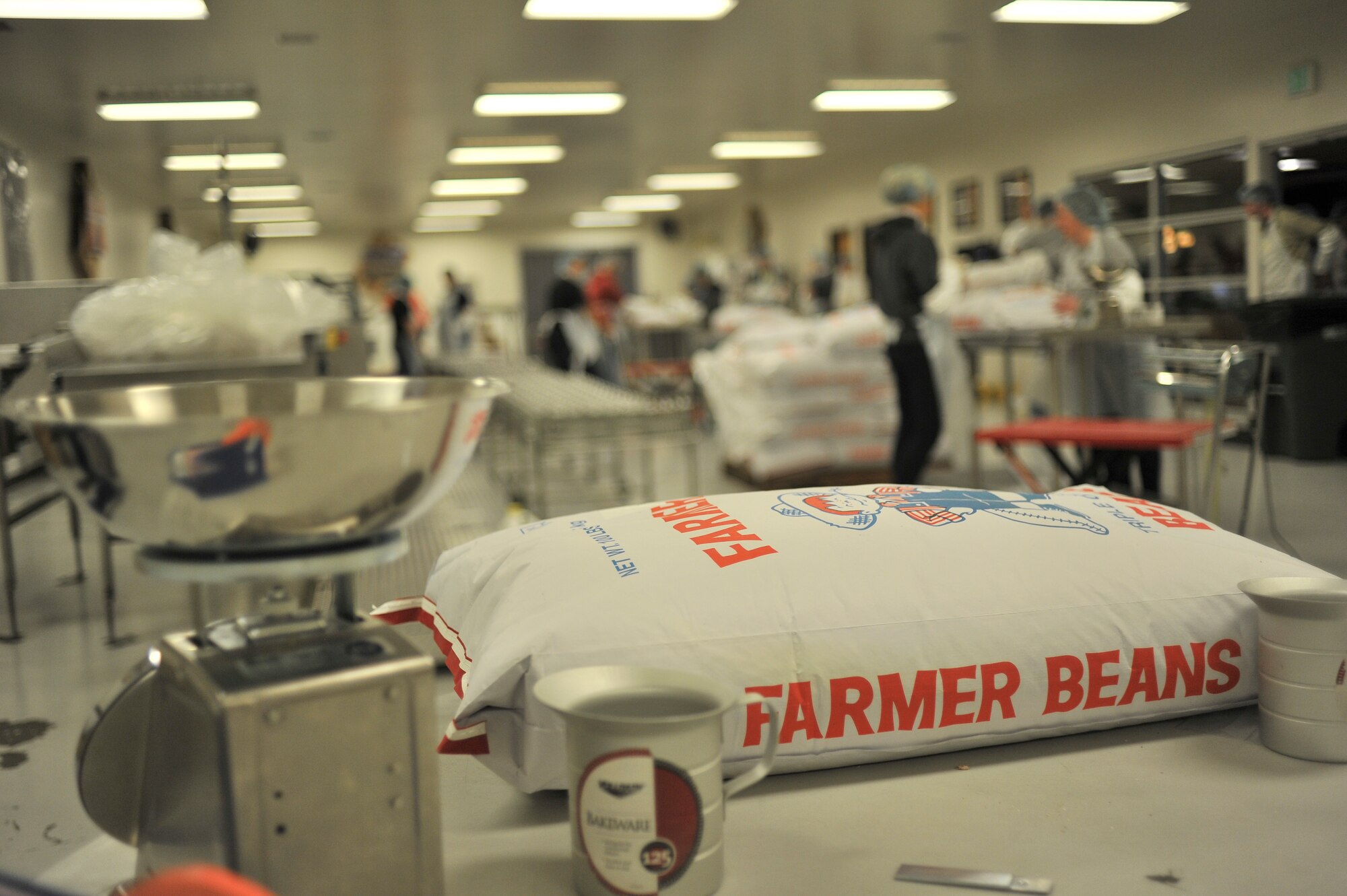 Students from the 66th Training Squadron volunteer work at Second Harvest Relief Network Spokane, Wash. March 31, 2014. Second Harvest has been serving the local community since 1971. Airmen from Fairchild have helped throughout the years to provide more than 2 Million pounds of food for families in 250 neighborhoods each year. (U.S. Air Force photo by Staff Sgt. Alexandre Montes /Released)