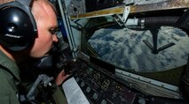 Tech. Sgt. Heath Tuma, 96th Air Refueling Squadron boom operator, prepares to refuel a B-52 Stratofortress in-flight April 2, 2014 over the Pacific Ocean near Joint Base Pearl Harbor-Hickam, Hawaii. This flight was in support of a mission in which two B-52 Stratofortress strategic bombers from Barksdale Air Force Base, La. and two B-2 Spirit strategic bombers from Whiteman Air Force Base, Mo., flew round trip non-stop from their respective home stations to training ranges within the vicinity ofin Hawaii and conducted range training operations and low approach training flights at JBPH-H. (U.S. Air Force photo by Staff Sgt. Nathan Allen)