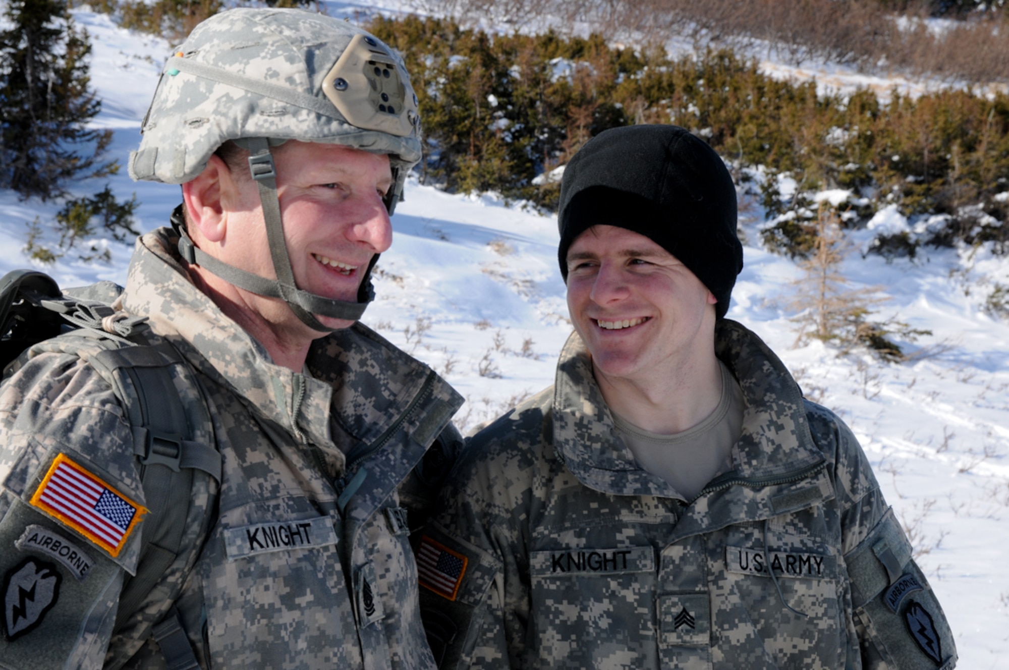Command Sgt. Maj. Bernie Knight, the senior enlisted adviser for U.S. Army Alaska, enjoys a father-son moment with his son, Sgt. Charles Knight, an infantryman with Apache Company, 1st Battalion, 501st Infantry Regiment, after jumping onto Geronimo Drop Zone March 20.  (U.S. Army photo/Staff Sgt. Jeffrey Smith)