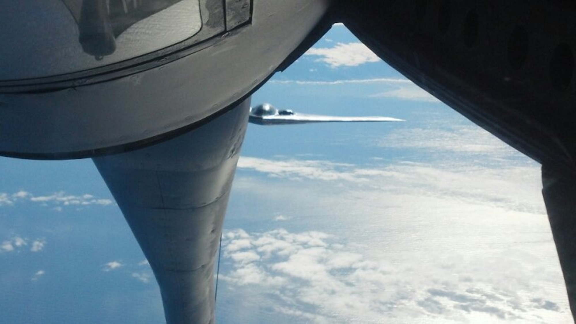 A B-2 Spirit bomber from Whiteman AFB, Mo., flies behind a KC-135 Stratotanker from Fairchild AFB, Wash., April 2, 2014, during a non-stop flight from Missouri to training ranges in Hawaii to exercise the president’s credible and flexible military options to meet national security obligations to the U.S. and its allies.  The 20-plus hour training missions also demonstrated the U.S.’ capability to provide a flexible and always-ready force to respond to a variety of threats and situations within U.S. Strategic Command’s global strike and strategic deterrence missions. KC-135 support for missions like this is vital to achieve rapid global mobility through air refueling capabilities. (Courtesy photo)