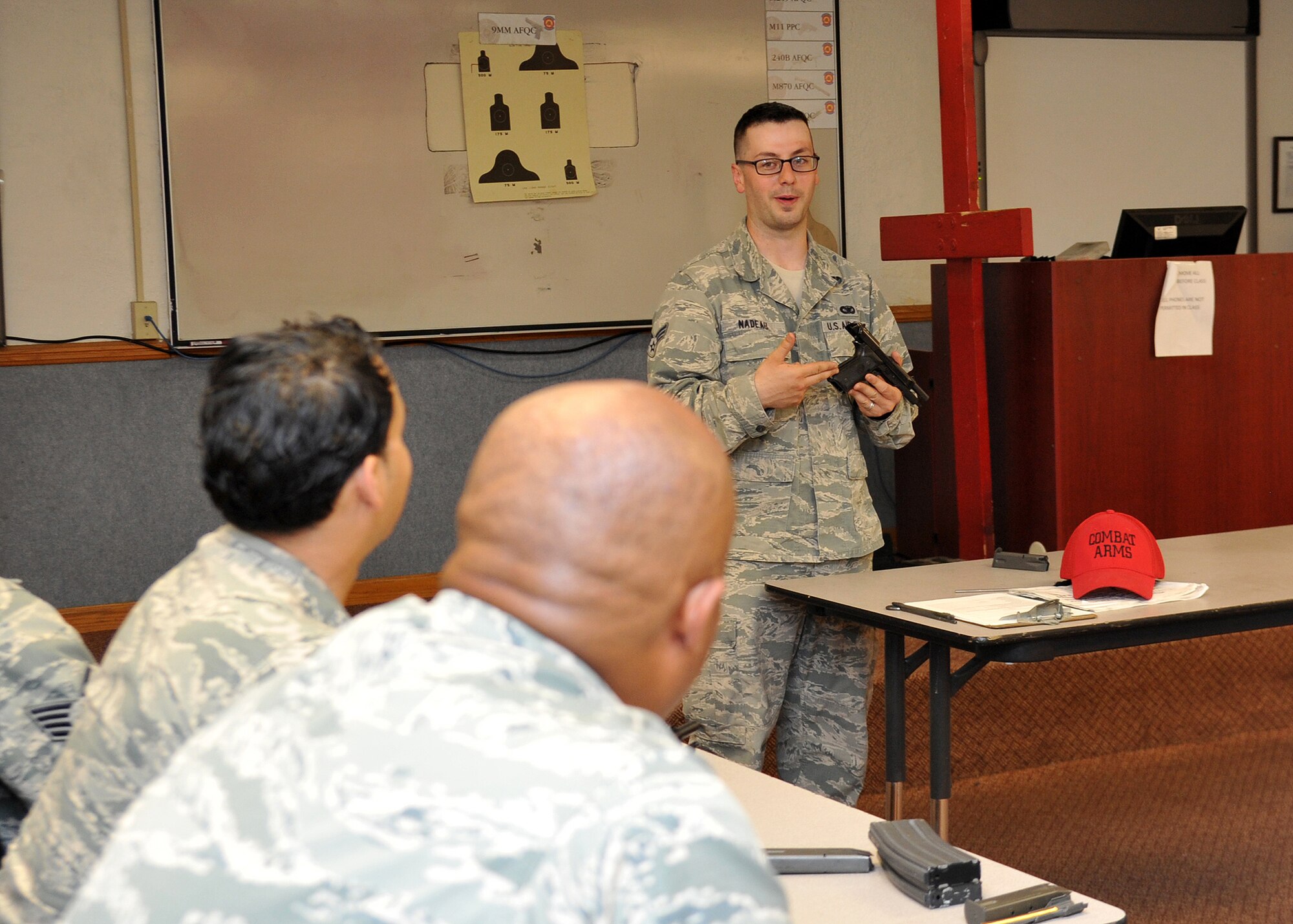 Senior Airman Andrew Nadeau, 56th Security Forces Squadron Combat Arms Training and Maintenance instructor, teaches about gun safety March 26 at Luke Air Force Base. CATM certifies personnel who need weapons qualification. (U.S. Air Force photo/Senior Airman Marcy Copeland)