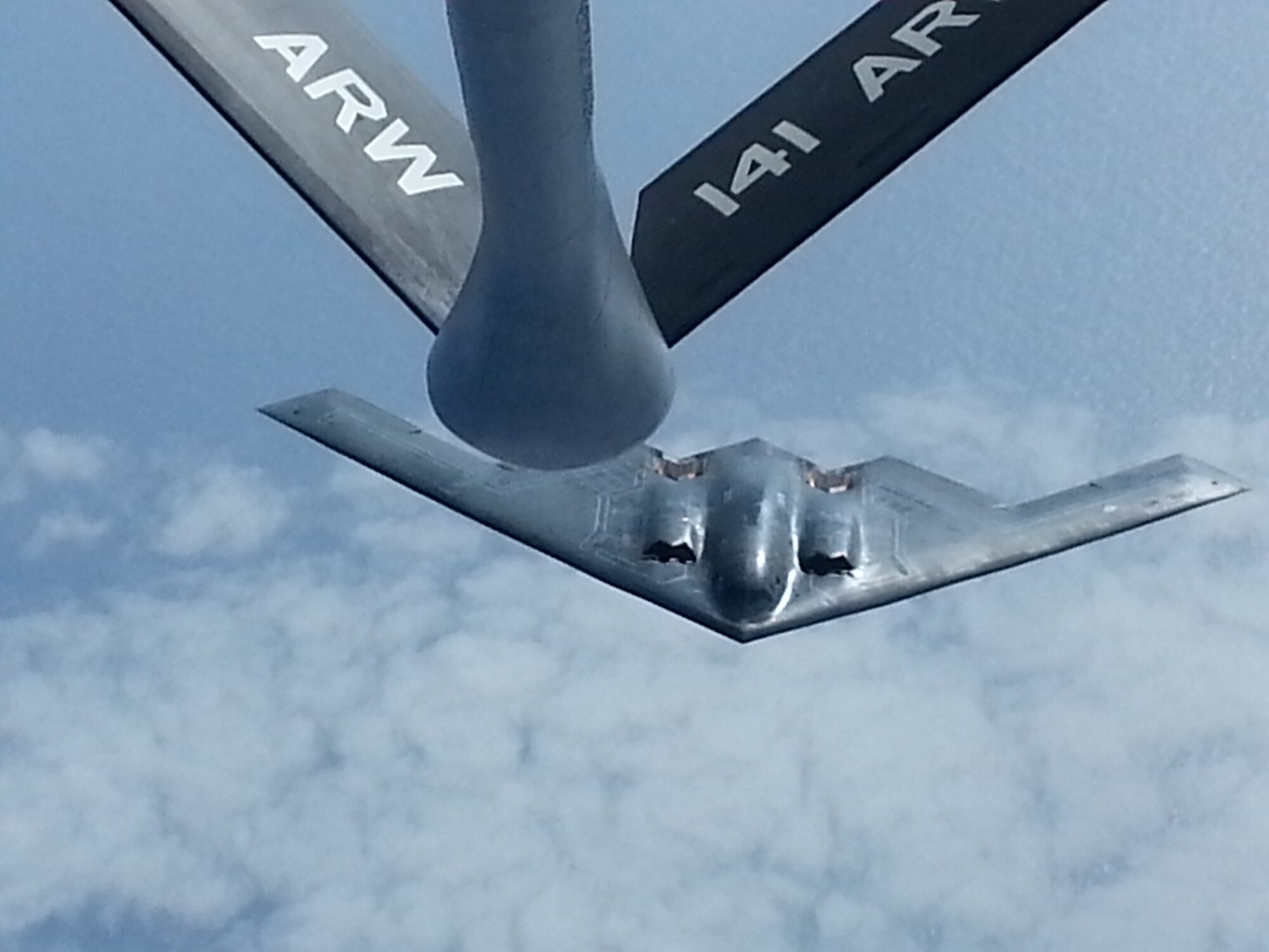 A B-2 Spirit bomber from Whiteman AFB, Mo., prepares to receive fuel from a KC-135 Stratotanker from Fairchild AFB, Wash., April 2, 2014, during a non-stop flight from Missouri to training ranges in Hawaii. The mission, which spanned nearly 8,000 miles from home station to drop site and back to home installation, helped the pilots hone their skills at operating during a long-duration flight; an important element of U.S. Strategic Command’s enduring deterrence capability. Supporting missions like this demonstrates the ability to achieve rapid global mobility through air refueling capabilities. (Courtesy photo)