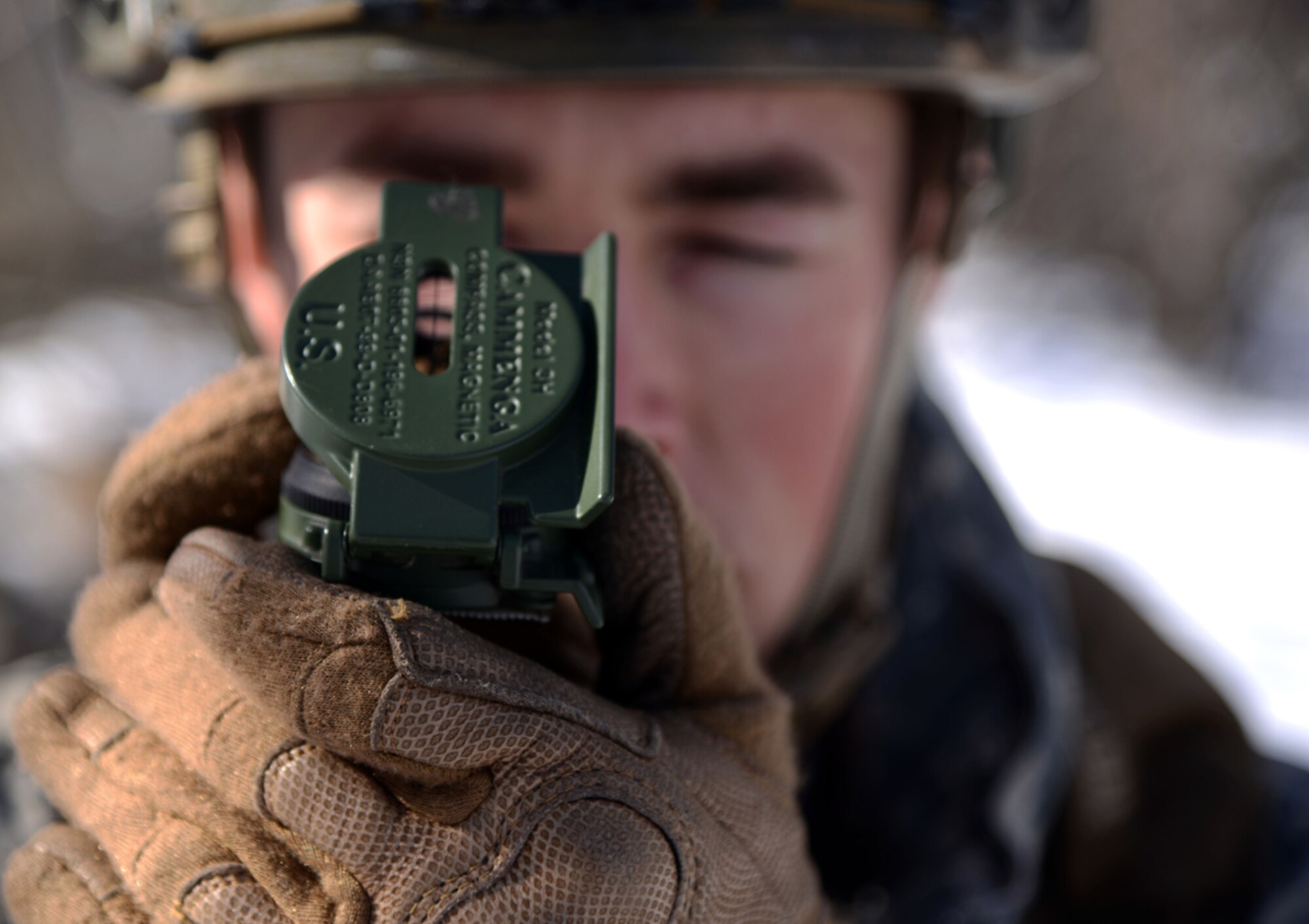 Air Force Staff Sgt. Travis Hunt, 3rd Air Support Operations Squadron joint terminal attack controller, uses a M-1950 lensatic field compass to determine the directions to his objective location point at Joint Base Elmendorf-Richardson, Alaska, March 26, 2014. Hunt recently graduated from the Army's Warrior Leadership Course and broke the record for the fastest land navigation. The land navigation course is to find four different point location set-up by the WLC instructors. (U.S. Air Force photo/Staff Sgt. Sheila deVera) 
