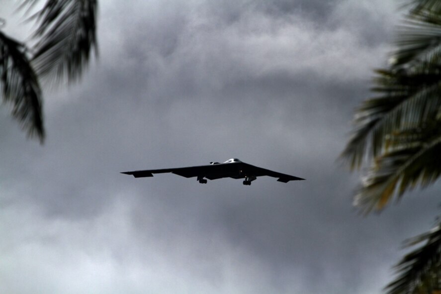 A B-2 Spirit strategic bomber conducts a low approach training flight over Joint Base Pearl Harbor-Hickam, Hawaii April 2, 2014.  Two B-52 Stratofortress strategic bombers from Barksdale Air Force Base, La. and two B-2 Spirit strategic bombers from Whiteman Air Force Base, Mo., flew non-stop from their respective home stations to training ranges within the vicinity of Hawaii and conducted range training operations and low approach training flights at Hickam AFB. (U.S. Marine Corps photographs by Staff Sgt. Jason Fudge)