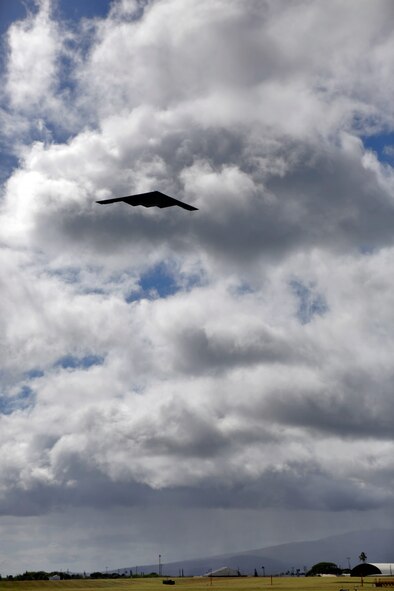 A B-2 Spirit strategic bomber conducts a low approach training flight over Joint Base Pearl Harbor-Hickam, Hawaii April 2, 2014.  Two B-52 Stratofortress strategic bombers from Barksdale Air Force Base, La. and two B-2 Spirit strategic bombers from Whiteman Air Force Base, Mo., flew non-stop from their respective home stations to training ranges within the vicinity of Hawaii and conducted range training operations and low approach training flights at Hickam AFB. (U.S. Marine Corps photograph by Lance Cpl. Wesley
Timm)