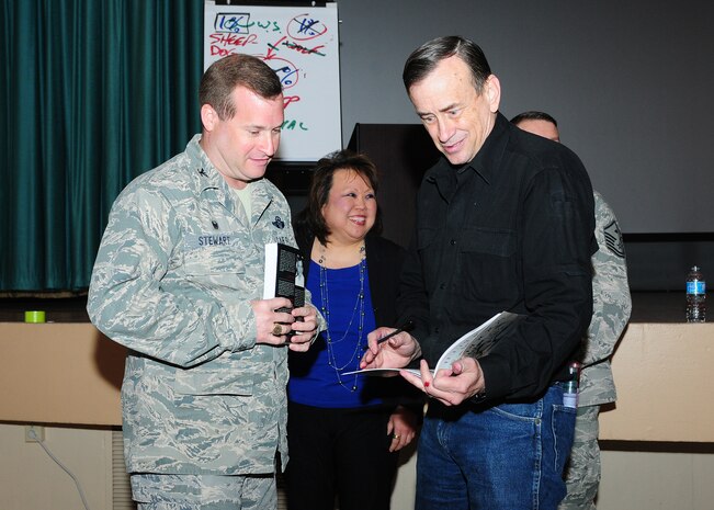 U.S. Army Lt. Col.  (Ret.) Dave Grossman (right), signs a book for Col. Phil Stewart, 9th Reconnaissance Wing commander, at the base theater Beale Air Force Base, Calif., April 2, 2014. Grossman is a former paratrooper, Army ranger, infantry commander, professor of military science and a West Point psychology professor who used his experiences to become the founder of Killology. (U.S. Air Force photo by Senior Airman Allen Pollard/Released)