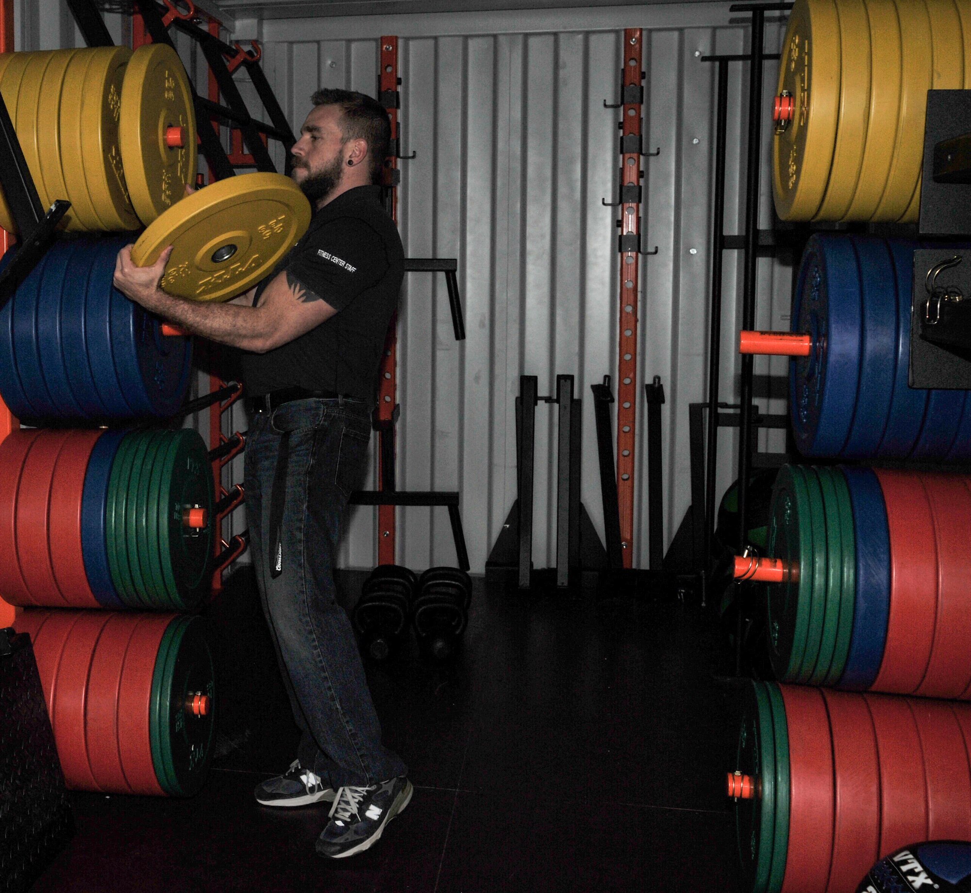 Michael Kaplan, 19th Force Support Squadron chief of fitness, grabs a weight for a bench press April 2, 2014, at Little Rock Air Force Base, Ark. The Rock recently received the new workout equipment for unit physical training leaders or unit fitness program managers to reserve and check out. (U.S. Air Force photos by Airman 1st Class Harry Brexel)