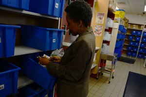 Rowena E. Nhart, USAF Hospital Langley pharmacy volunteer, fills a prescription for a patient at the satellite pharmacy at Langley Air Force Base, Va., April 2, 2014. With the hospital pharmacy supporting no less than 400 Service members and family members each day, activating and filling nearly 1,200 prescriptions, volunteers expedite the process of getting a patient their medication. (U.S. Air Force photo by Airman 1st Class Kimberly Nagle/Released)