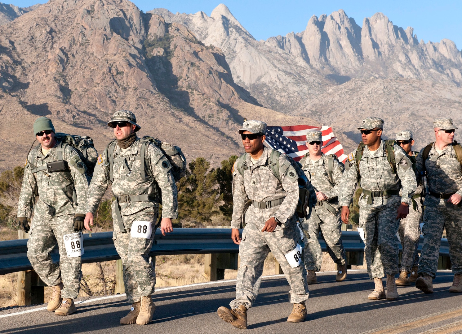 Three members of U.S. Army South’s 1st Battlefield Coordination Detachment lead the pack as they march along the highway during the 25th Bataan Memorial Death March at White Sands Missile Range, N.M. March 23. More than 25 Army South Soldiers participated in the Bataan MDM. Open To military and civilian teams and individuals in either heavy or light divisions, the Bataan Memorial Death March honors a special group of World War II heroes who were captured by Japanese forces and marched for days in the scorching heat through the Philippine jungles in 1942. Thirteen World War II Bataan veterans were in attendance to watch the march.
Photo by Robert R. Ramon