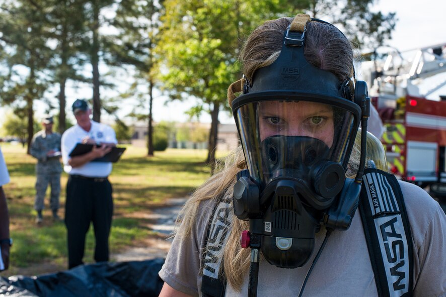 U.S. Air Force Airman 1st Class Erin Johnson, 23d Civil Engineer Squadron emergency management apprentice, removes her biohazard suit after being decontaminated during a chemical, biological, radiological and nuclear exercise at Moody Air Force Base, Ga., April 3, 2014. Johnson responded to the scene in order to identify and contain an unknown chemical substance. (U.S. Air Force photo by Airman 1st Class Ryan Callaghan/Released)
