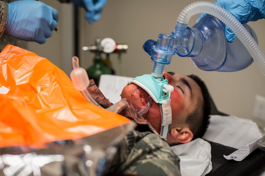 A patient is given simulated breaths during a chemical, biological, radiological and nuclear major accident response exercise at Moody Air Force Base, Ga., April 3, 2014. Airmen involved in the exercise simulated symptoms correlating with varying exposure to a chemical agent. (U.S. Air Force photo by Airman 1st Class Ryan Callaghan/Released)