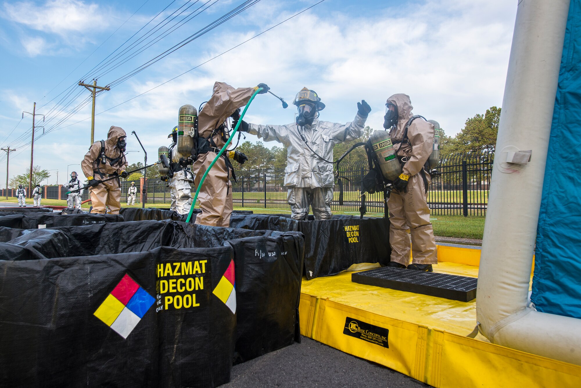 Firefighters from the 23d Civil Engineer Squadron decontaminate each other during a chemical, biological, radiological and nuclear major accident response exercise at Moody Air Force Base, Ga., April 3, 2014. Airmen proceeded through a multi-stage decontamination process after any potential exposure. (U.S. Air Force photo by Airman 1st Class Ryan Callaghan/Released)