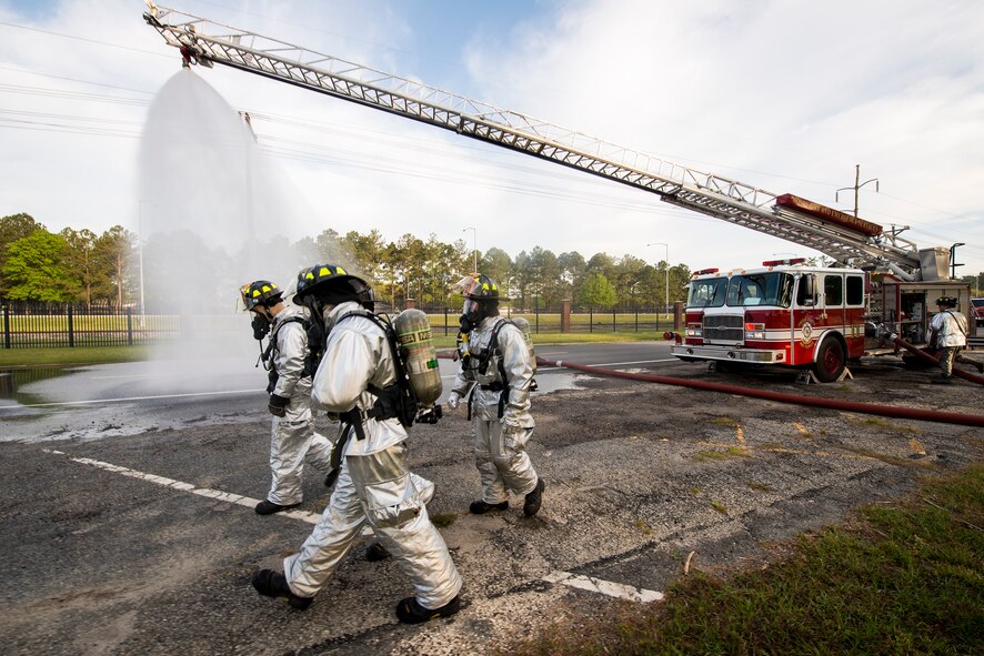 Firefighters from the 23d Civil Engineer Squadron respond to a suspected chemical attack during an exercise at Moody Air Force Base, Ga., April 3, 2014. Airmen deployed a fire hose to douse walking casualties as they were removed from the scene in order to minimize the spread of potentially dangerous chemicals to medical responders. (U.S. Air Force photo by Airman 1st Class Ryan Callaghan/Released)