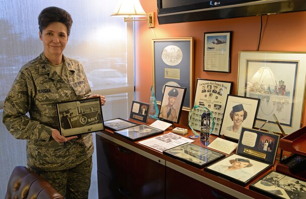 Col. Katherine Rearden, 59th Medical Wing Clinical Research Division chief, proudly displays her family’s Air Force heritage in her office on Joint Base San Antonio-Lackland, Texas March 28, 2014. Rearden holds a picture of her grandfather, who she credits with her love of the flying community. In the photo, he is presented with an award from the Army and Navy for his role in General Motors’ conversion from making cars to the Grumman Avenger in World War II. (U.S. Air Force photo/Staff Sgt. Christopher Carwile)
