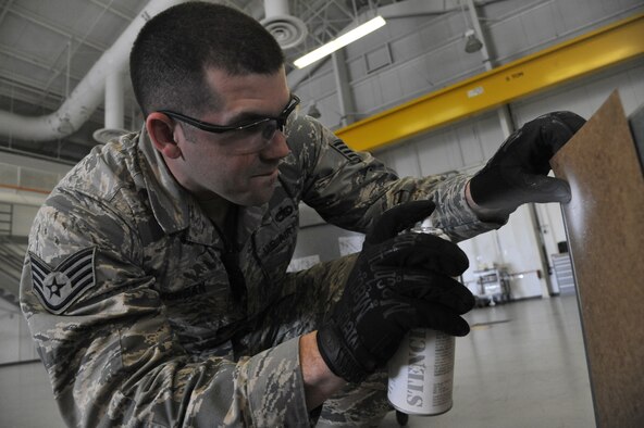 U.S. Air Force Staff Sgt. Kenneth Morgan, 509th Munitions Squadron conventional maintenance section crew chief, marks the amount of KMU-556 tail kits in a storage container. The 509th Munitions Squadron conventional maintenance section is responsible for building, testing and maintaining munitions for different aircraft. (U.S. Air Force photo by Airman 1st Class Keenan Berry/Released)